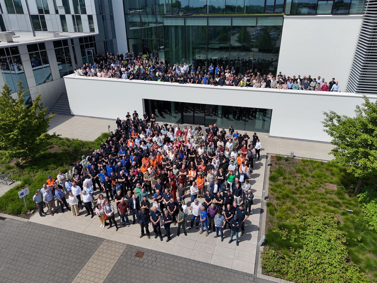 Fotografía grupal de empleados frente al Reynaers Campus.