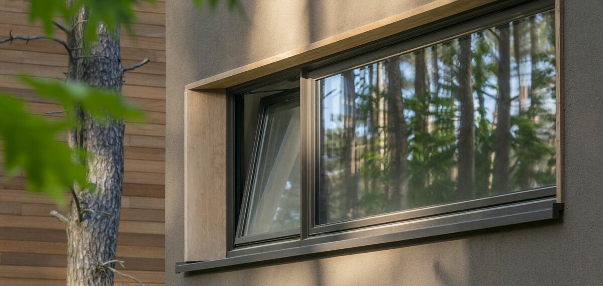 Turn-tilt window in private Polish home, with tree on the side.