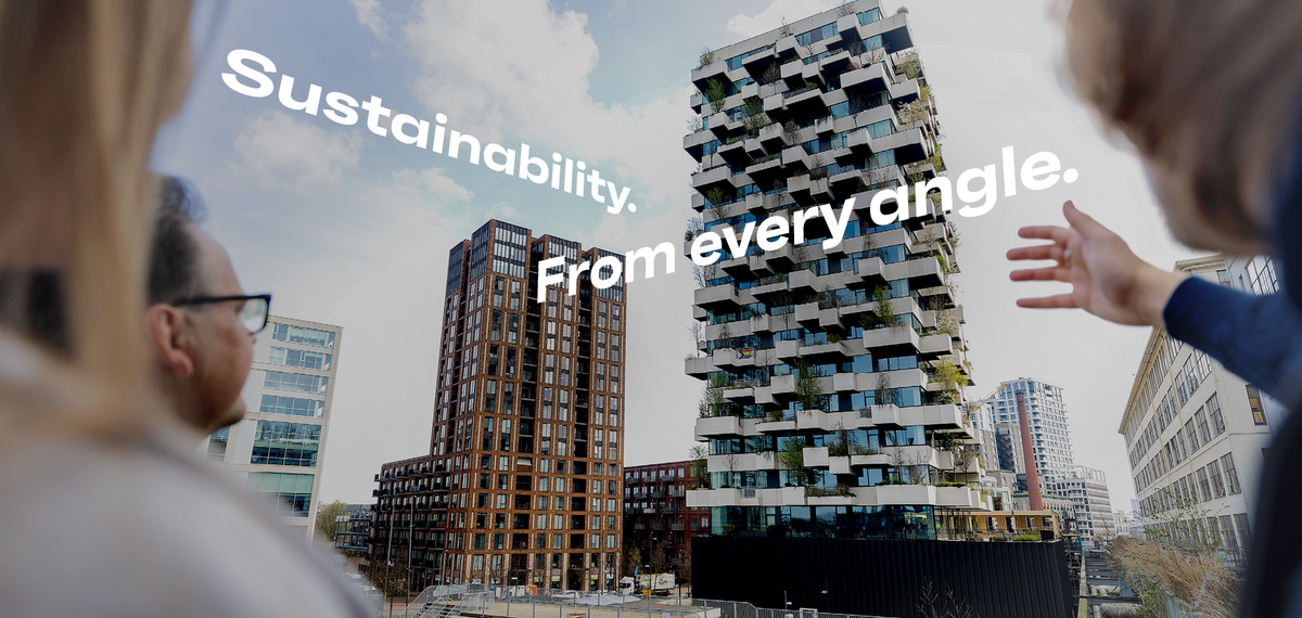 Man and woman pointing at green building in Eindhoven.