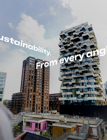 Man and woman pointing at green building in Eindhoven.